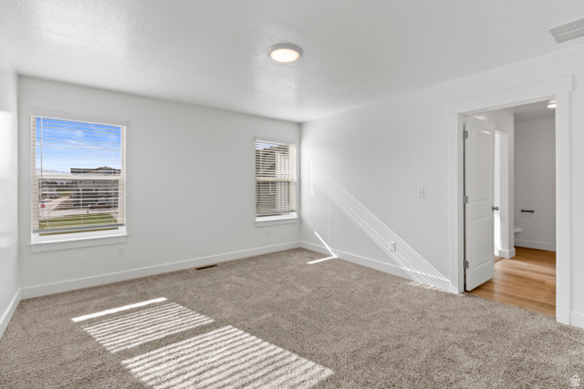 1271 West 500 South Logan, UT 84321 - Photo 12 of 26 Carpeted room featuring dual windows with blinds, a flush mount ceiling light, and white trim
