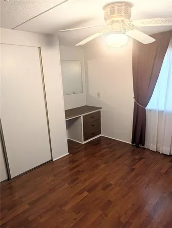 an empty room with wooden floor and entrance