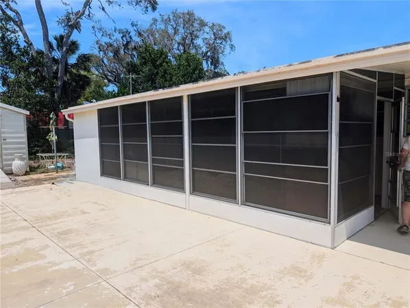 a view of a house with a large window and a yard