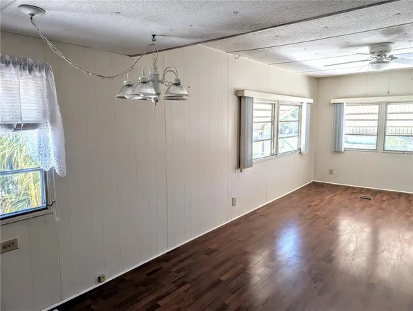 a view of a room with wooden floor and windows