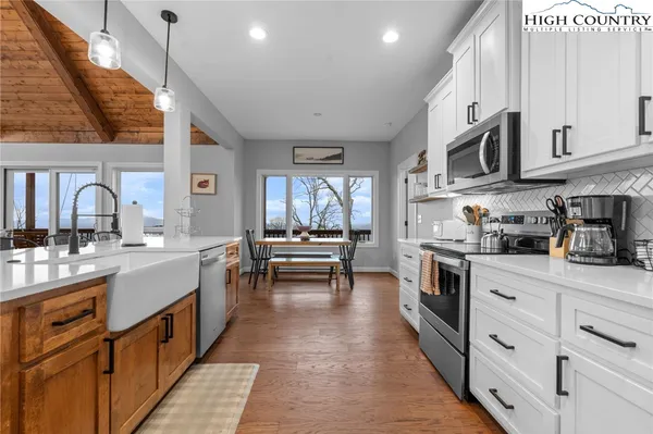 a large kitchen with a table and chairs in it