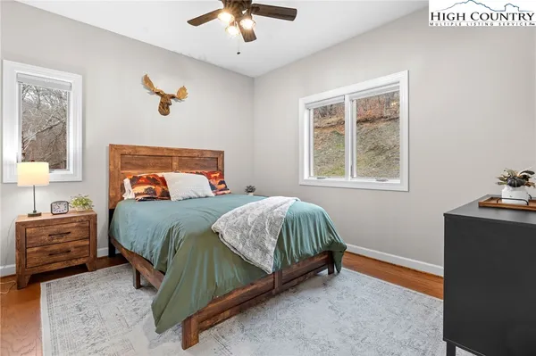 a bedroom with a bed and wooden floor