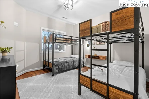 a bedroom with a bed and a mirror