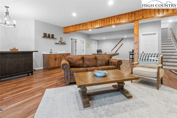 a room with furniture pool table and wooden floor