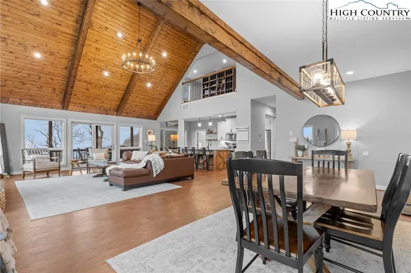 a kitchen with kitchen island a stove a table and chairs in it