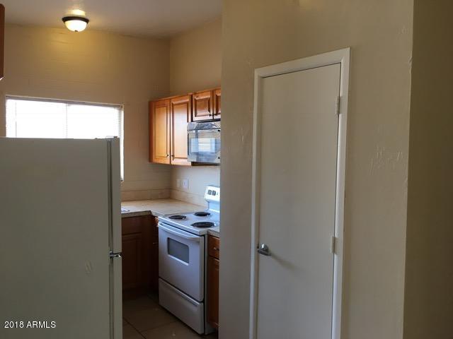 7106 North 68th Avenue, Unit 1 Glendale, AZ 85303 - Photo 9 of 22 a kitchen with stainless steel appliances a refrigerator sink and stove