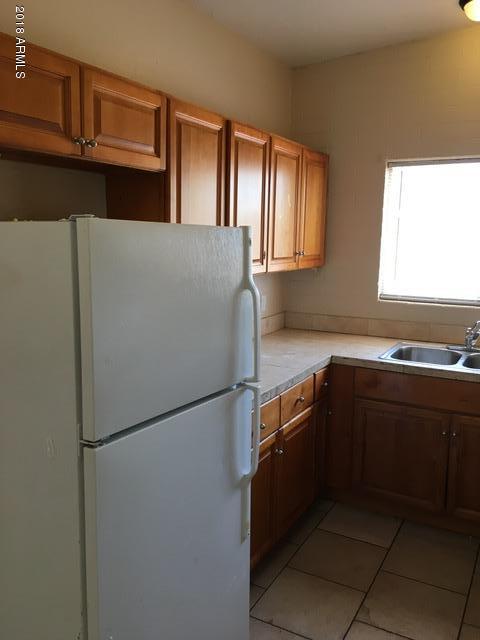7106 North 68th Avenue, Unit 1 Glendale, AZ 85303 - Photo 10 of 22 a kitchen with a refrigerator and a sink