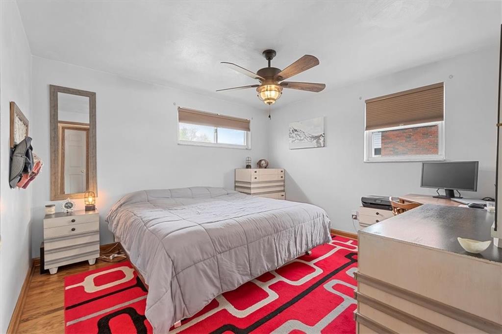 666 Lindsay Road Carnegie, PA 15106 - Photo 11 of 25 a bedroom with a bed and a chandelier