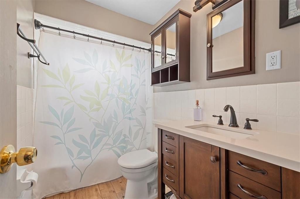 666 Lindsay Road Carnegie, PA 15106 - Photo 15 of 25 a bathroom with a granite countertop sink toilet and shower