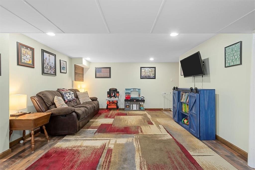 666 Lindsay Road Carnegie, PA 15106 - Photo 17 of 25 a living room with furniture and a flat screen tv