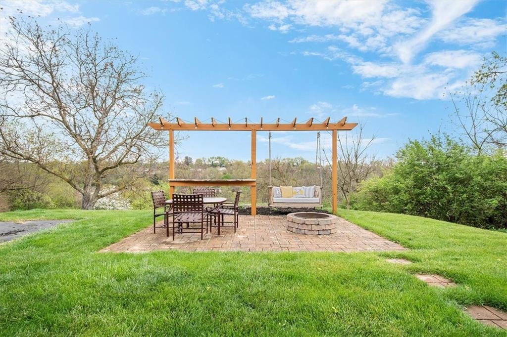 666 Lindsay Road Carnegie, PA 15106 - Photo 24 of 25 a view of a patio with a table chairs and a fire pit
