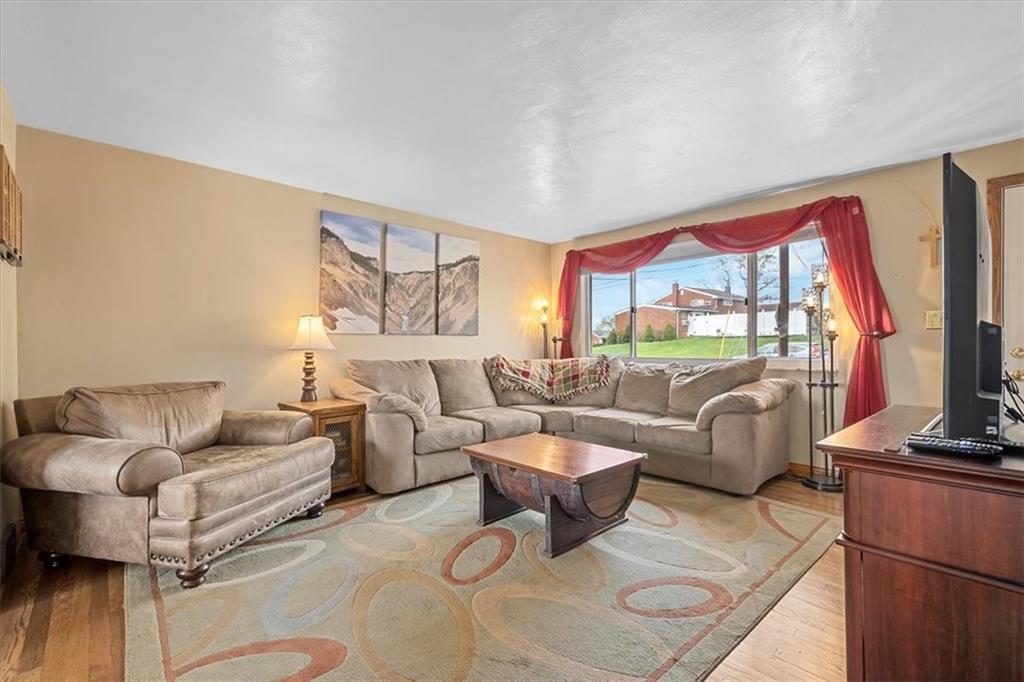 666 Lindsay Road Carnegie, PA 15106 - Photo 4 of 25 a living room with furniture and a floor to ceiling window