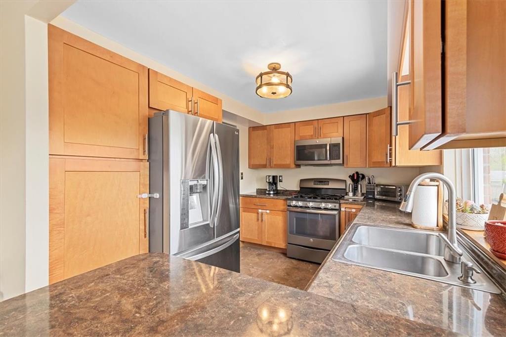 666 Lindsay Road Carnegie, PA 15106 - Photo 9 of 25 a kitchen with stainless steel appliances granite countertop a refrigerator a stove top oven a sink and dishwasher
