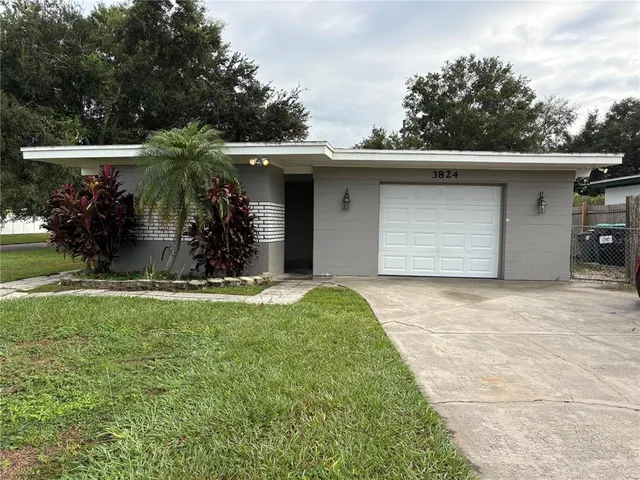 a view of a house with a yard and garage