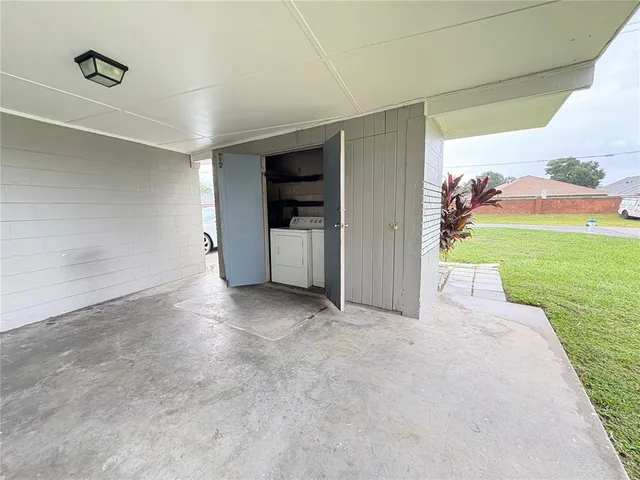 a view of a porch with furniture and a yard