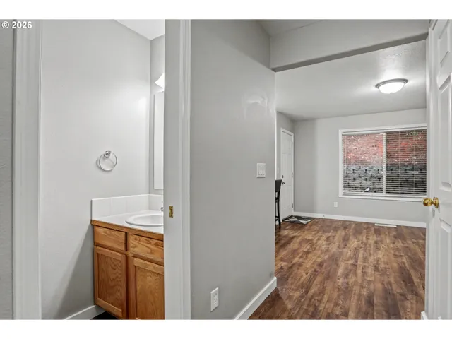 a view of empty room with wooden floor