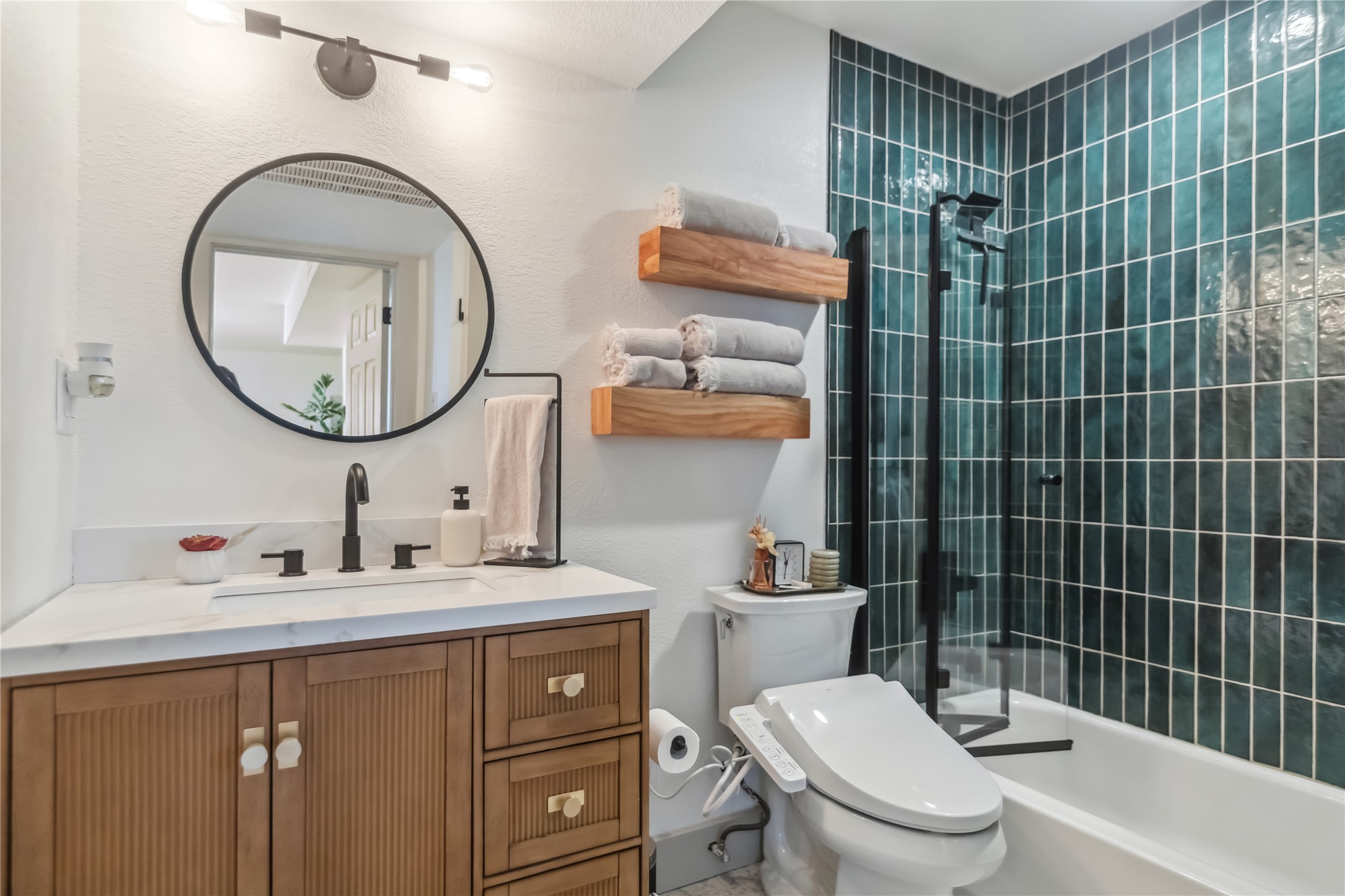 1313 East 52nd Street, Unit 101 Austin, TX 78723 - Photo 1 of 14 a bathroom with a sink toilet and a mirror