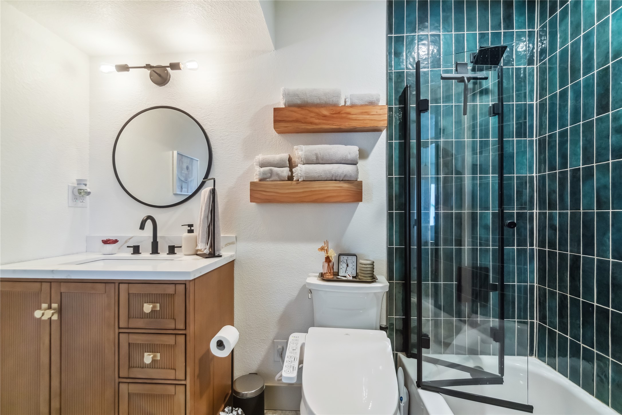 1313 East 52nd Street, Unit 101 Austin, TX 78723 - Photo 2 of 14 a bathroom with a toilet a sink and mirror