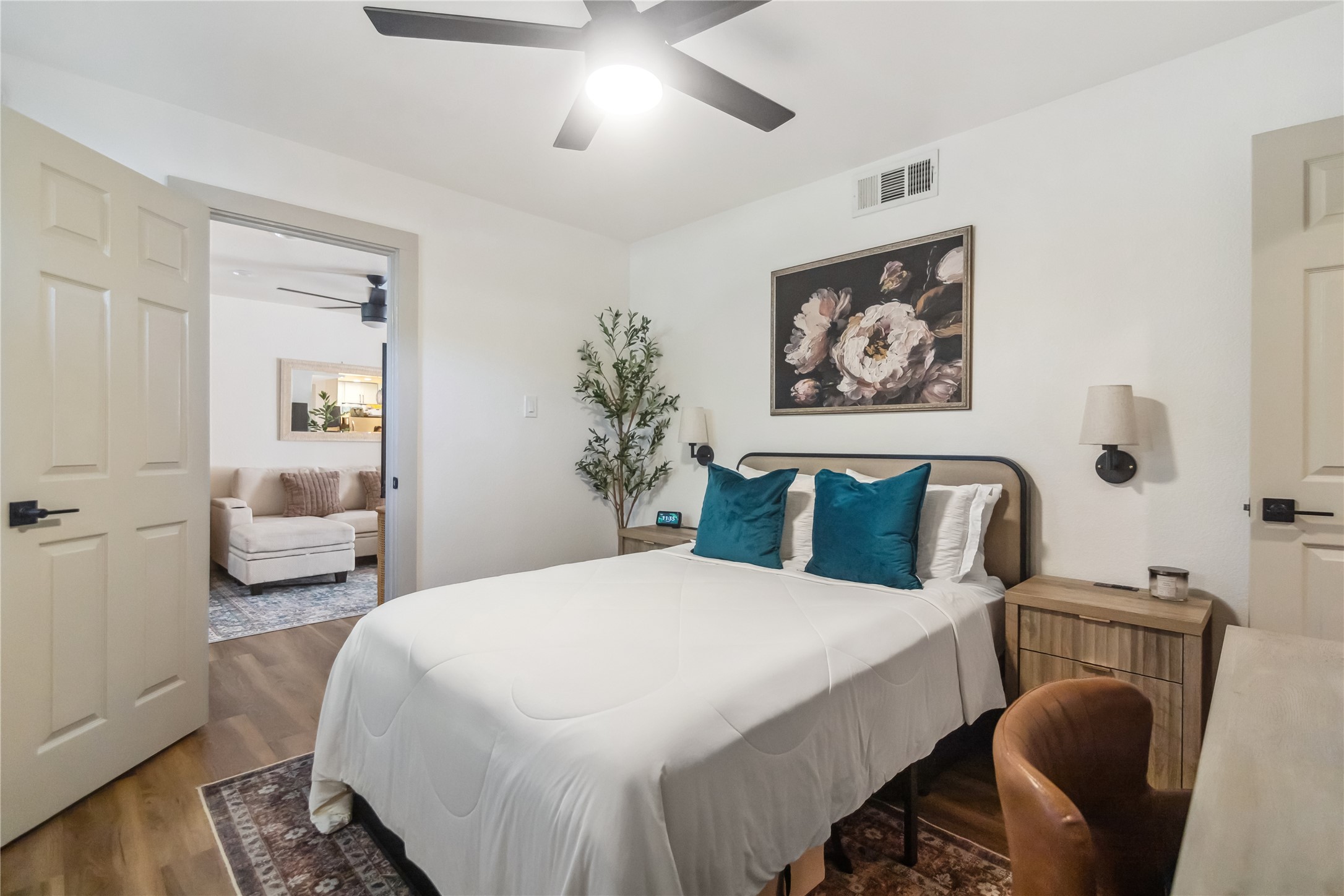 1313 East 52nd Street, Unit 101 Austin, TX 78723 - Photo 8 of 14 a bedroom with a large bed and a chandelier