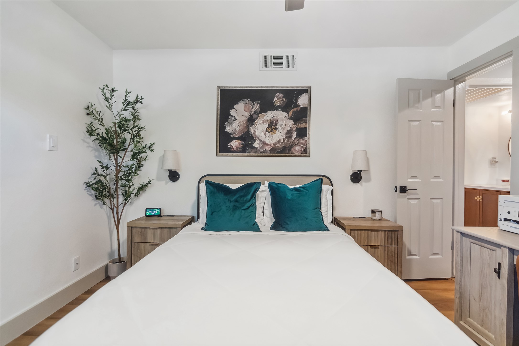 1313 East 52nd Street, Unit 101 Austin, TX 78723 - Photo 9 of 14 a bedroom with a large bed and a chandelier