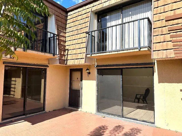 a view of a brick house with a large windows