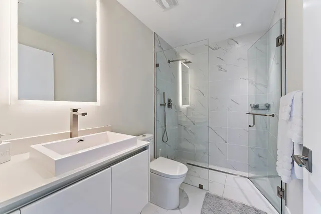 a bathroom with a sink toilet and shower