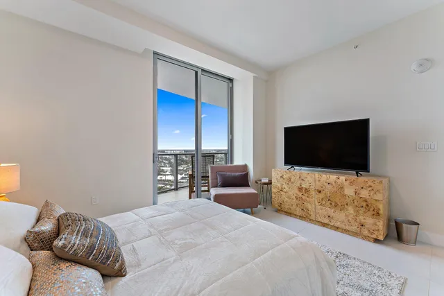 a bedroom with a bed and a flat screen tv