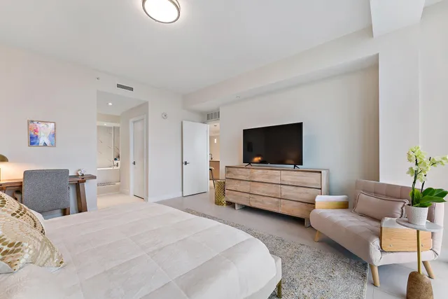 a bedroom with furniture and a flat screen tv