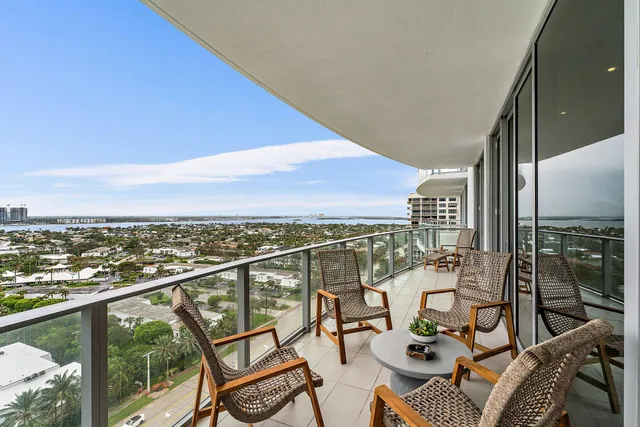 a view of a balcony with chairs and wooden floor