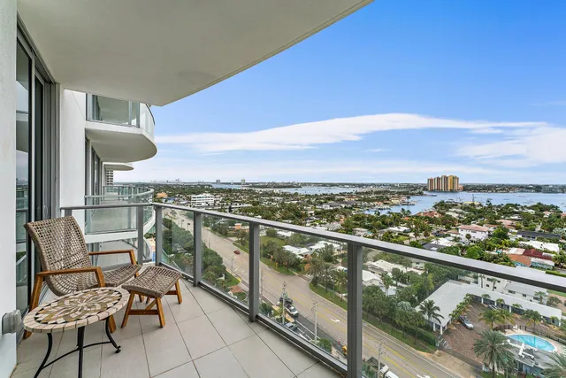 a view of a chairs and table in balcony