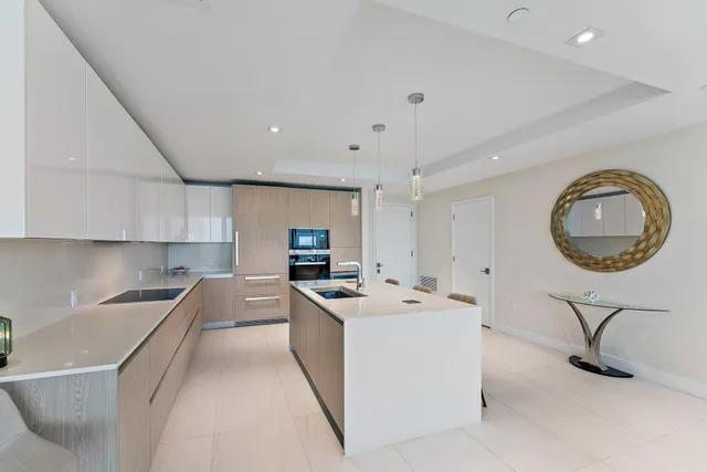 a kitchen that has a sink a stove and a table in it