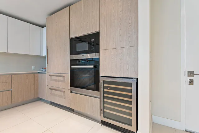 a kitchen with white cabinets and white appliances