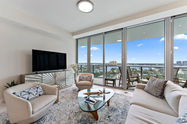 a living room with furniture and a large window