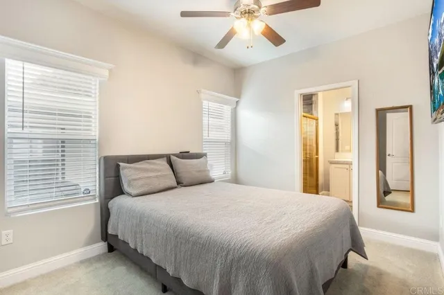 a bedroom with a bed and a painting on the wall