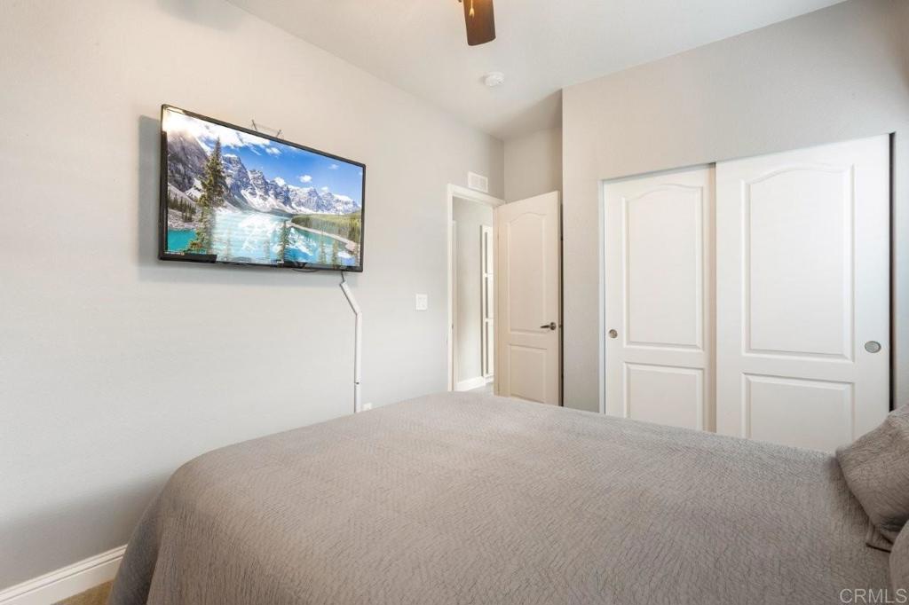 3505 Alpine Boulevard, Unit 15 Alpine, CA 91901 - Photo 16 of 23 a bedroom with a bed and a painting on the wall