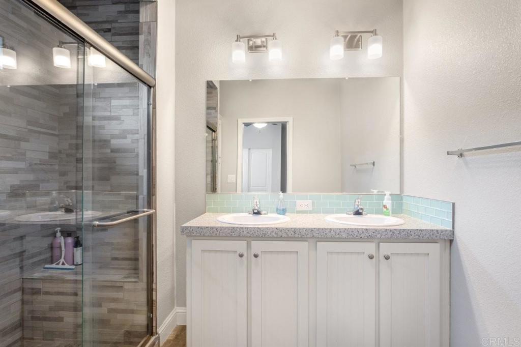 3505 Alpine Boulevard, Unit 15 Alpine, CA 91901 - Photo 17 of 23 a bathroom with a double vanity sink and a mirror