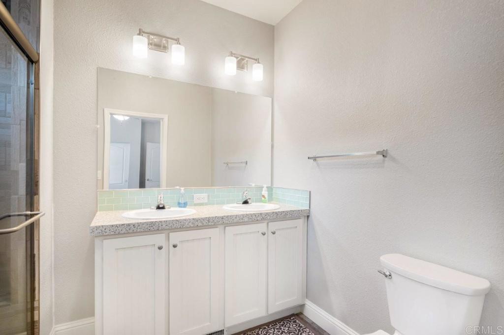 3505 Alpine Boulevard, Unit 15 Alpine, CA 91901 - Photo 19 of 23 a bathroom with a toilet sink and mirror