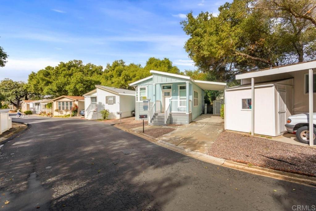 3505 Alpine Boulevard, Unit 15 Alpine, CA 91901 - Photo 20 of 23 a front view of a house with a yard and garage