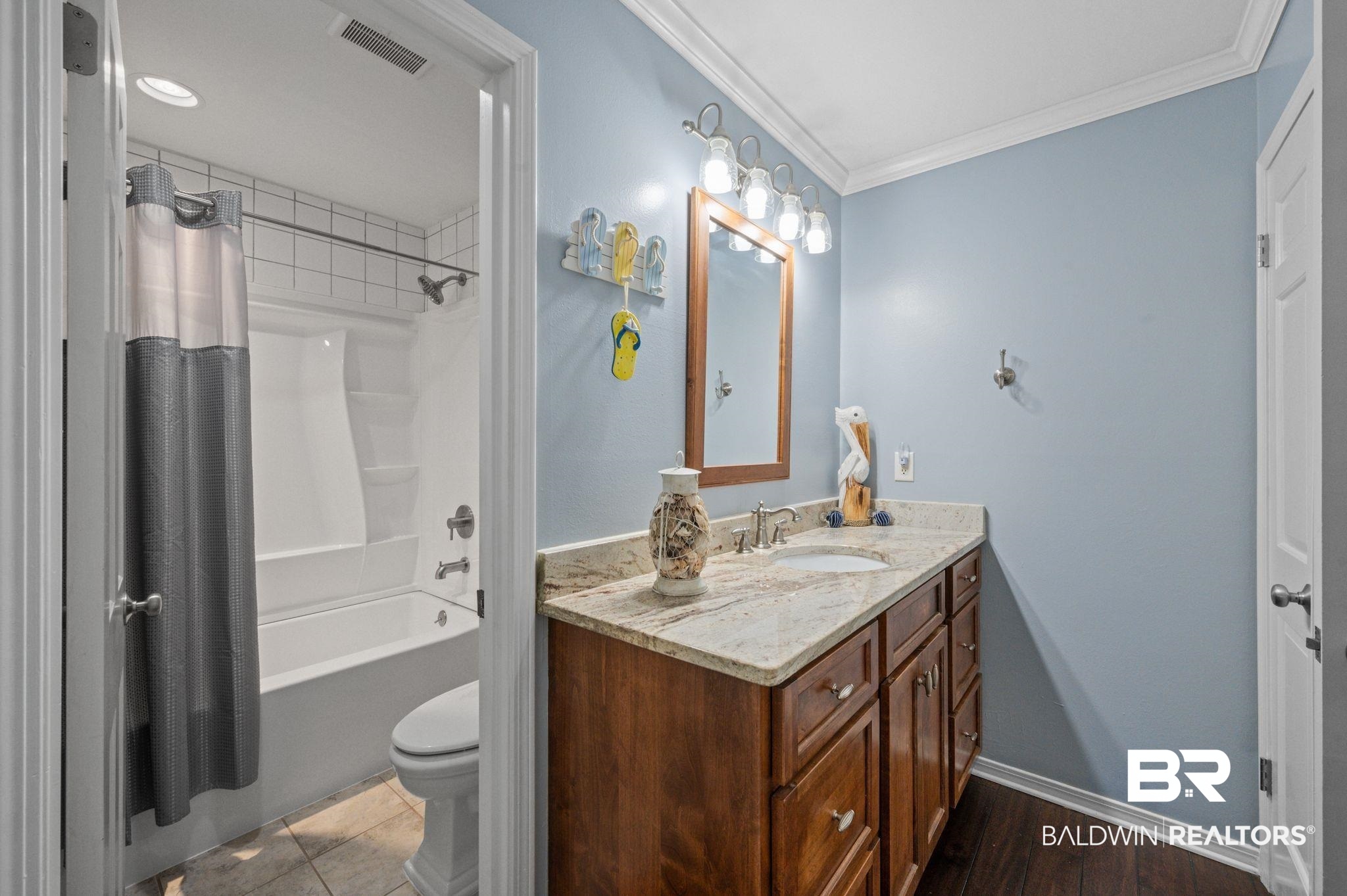 20037 County Road 33 Fairhope, AL 36532 - Photo 29 of 79 Full bathroom with shower / bath combo, hardwood / wood-style flooring, toilet, crown molding, and vanity
