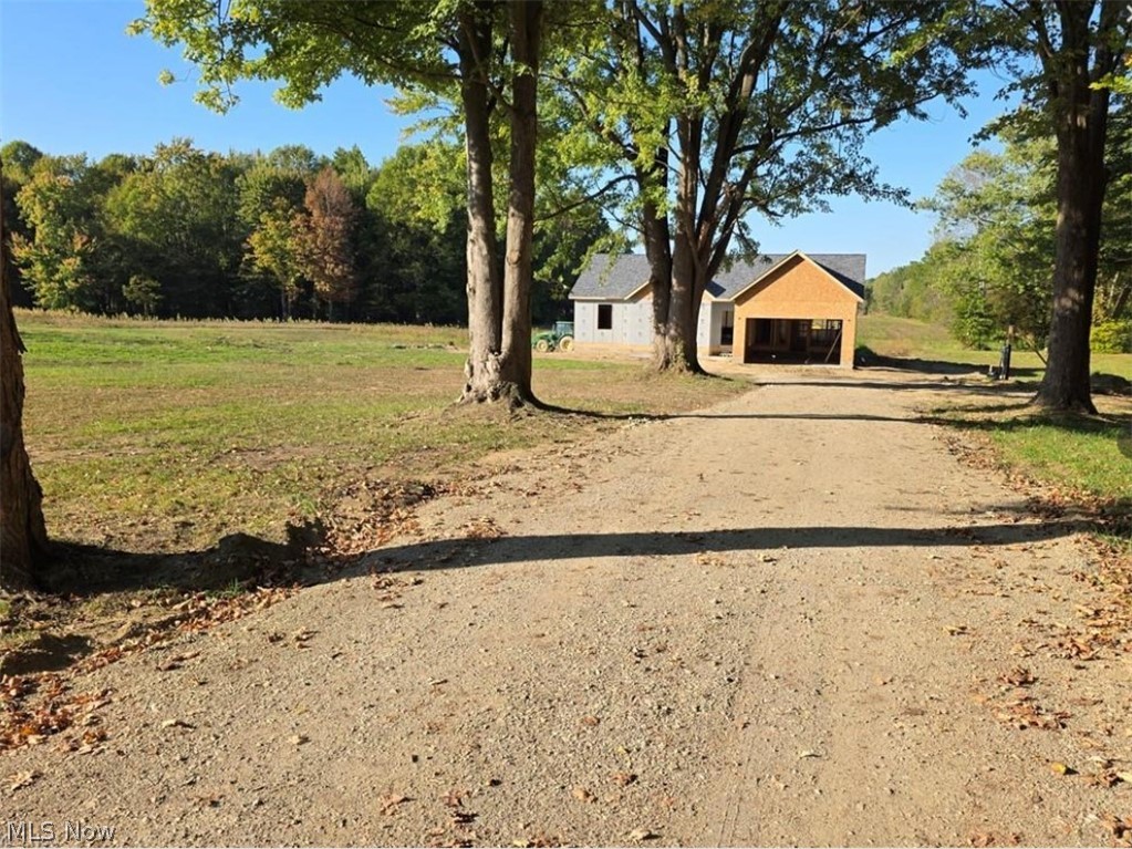 6535 North Ridge Road West Geneva, OH 44041 - Photo 45 of 48 View of grassy yard featuring driveway and a garage