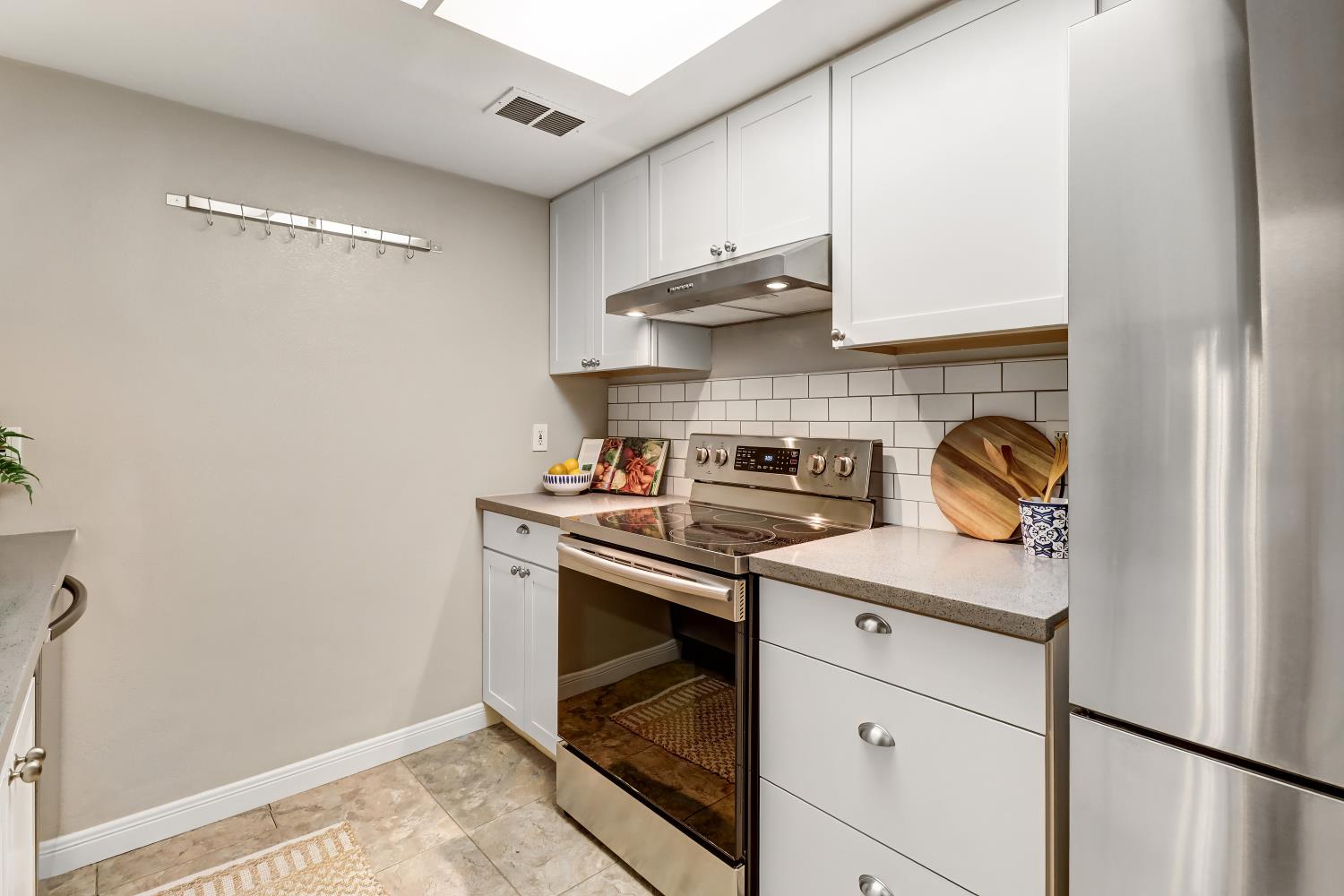 2317 East 8th Street Davis, CA 95618 - Photo 18 of 42 a kitchen with stainless steel appliances granite countertop a sink and a stove
