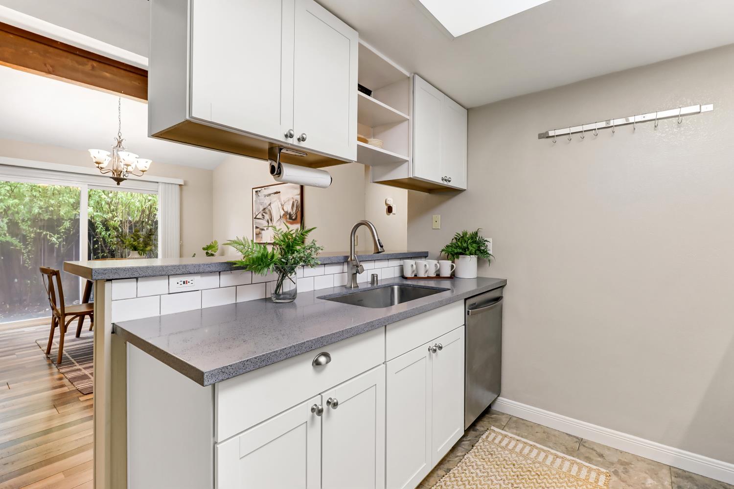 2317 East 8th Street Davis, CA 95618 - Photo 21 of 42 a kitchen with stainless steel appliances a sink a table and chairs in it
