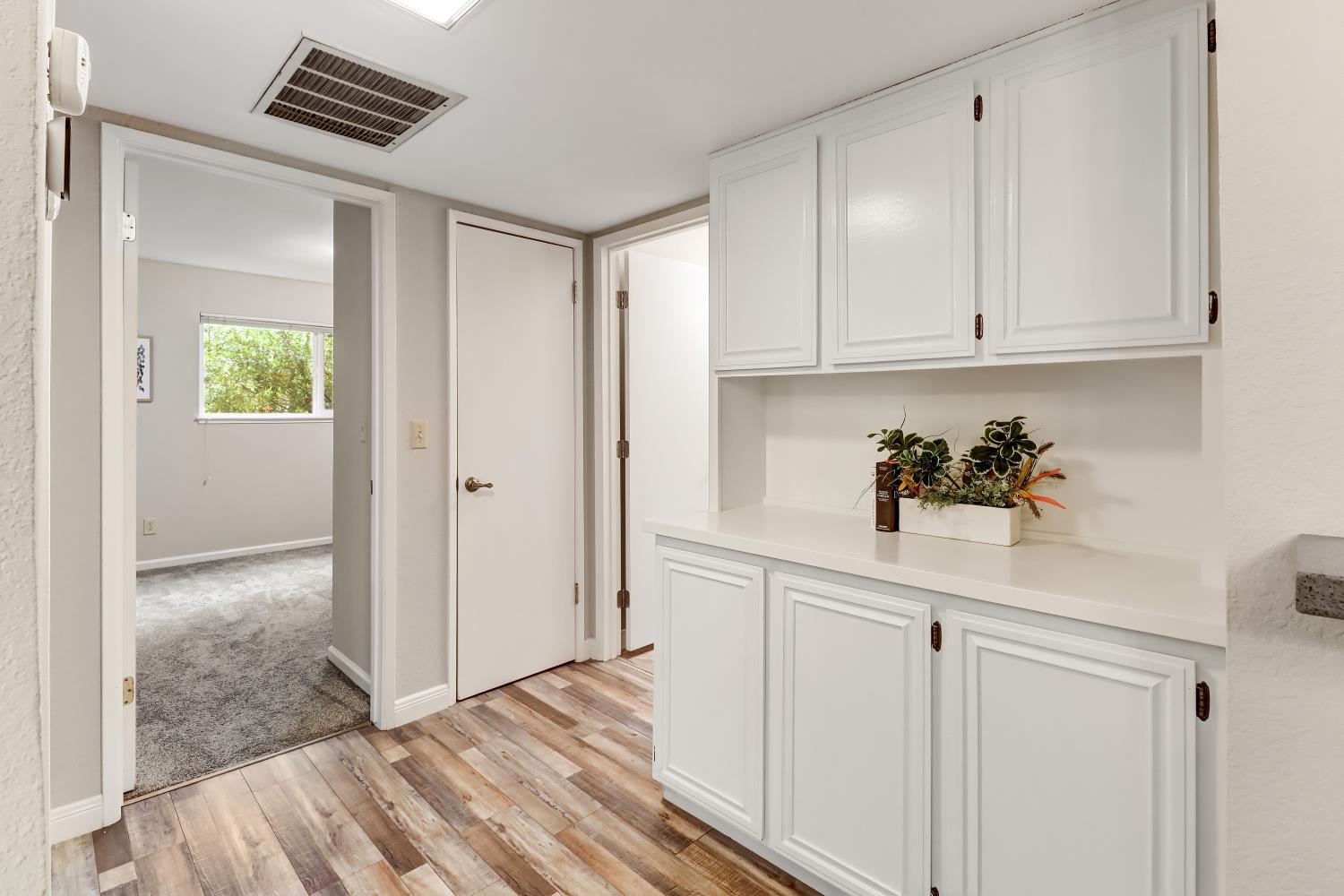 2317 East 8th Street Davis, CA 95618 - Photo 23 of 42 a kitchen with white cabinets and window