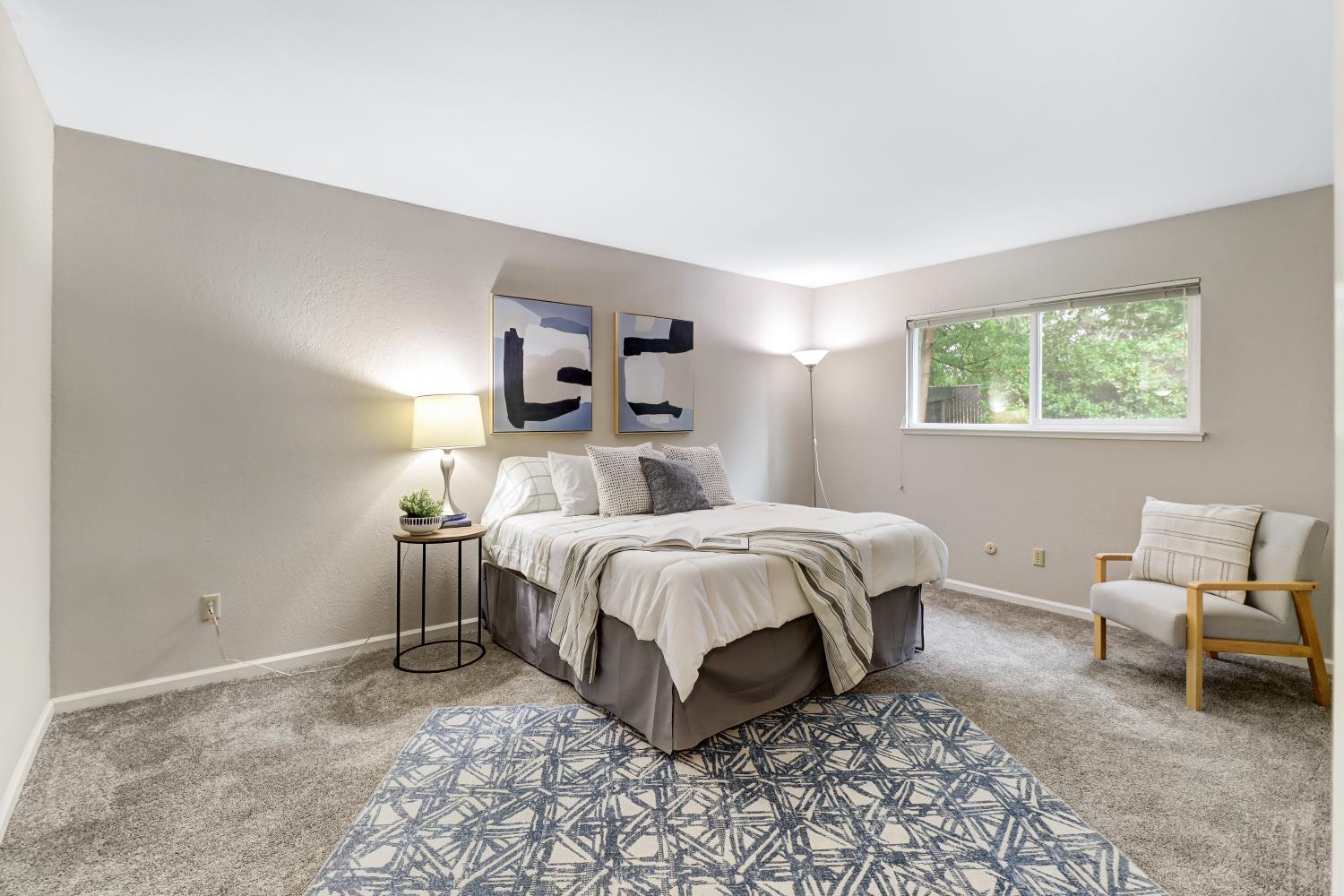 2317 East 8th Street Davis, CA 95618 - Photo 24 of 42 a spacious bedroom with a bed and a couch