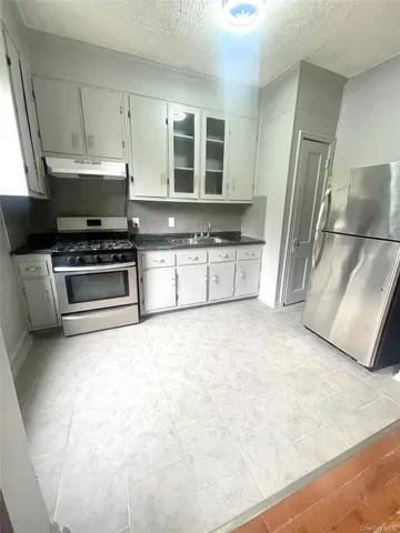 a kitchen with stainless steel appliances a stove a refrigerator and a sink