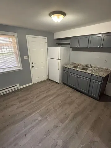 a kitchen with granite countertop a refrigerator and a stove