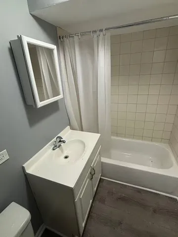 a bathroom with a sink a toilet and bathtub