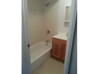 a bathroom with a sink a mirror and a bathtub