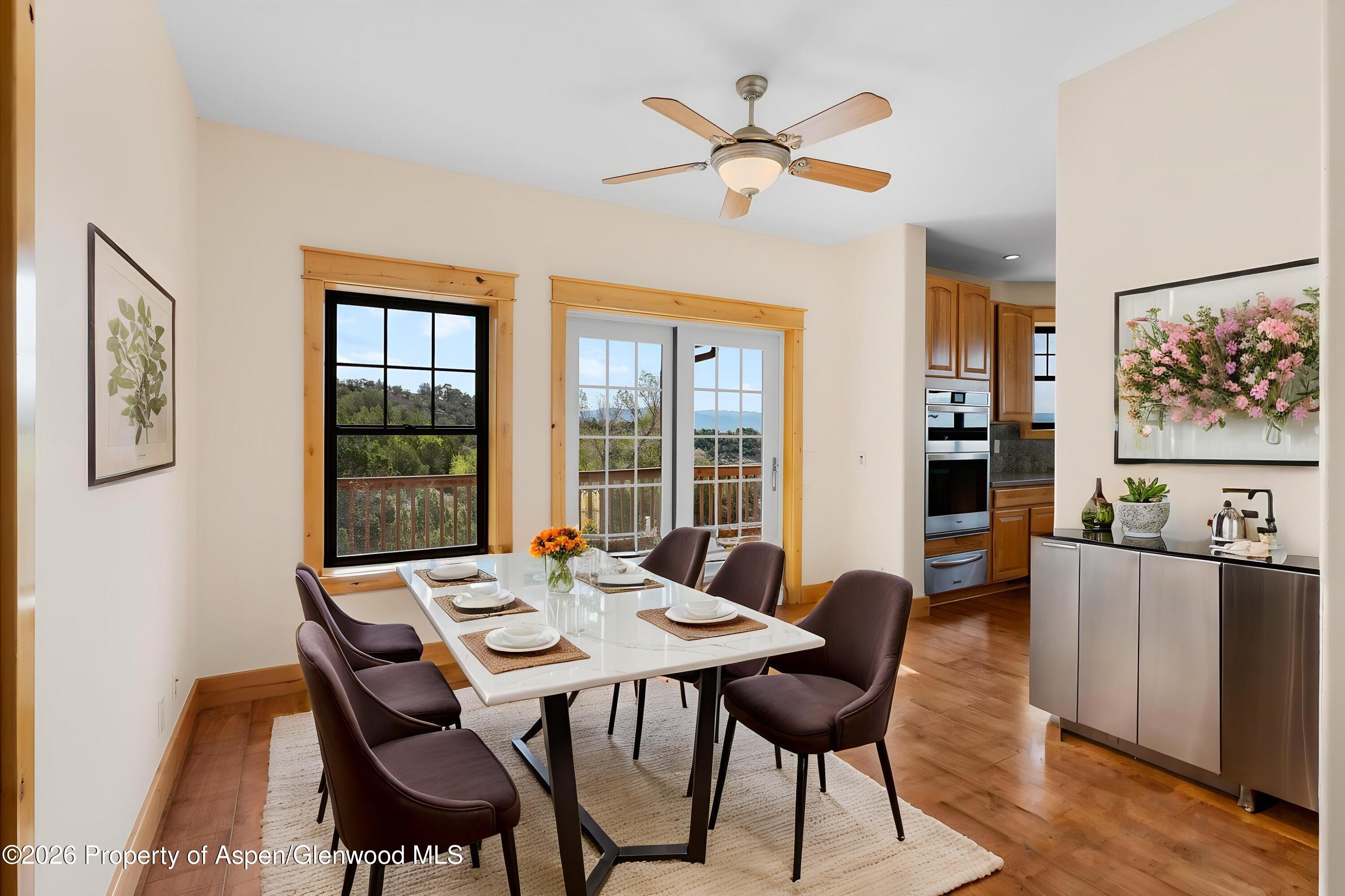 450 Summer Falls Road Silt, CO 81652 - Photo 4 of 50 a view of a dining room with furniture window and wooden floor