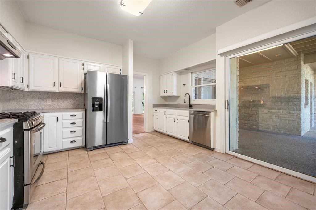 6 Sunview Road The Hills, TX 78738 - Photo 13 of 19 a kitchen with stainless steel appliances a refrigerator sink and cabinets